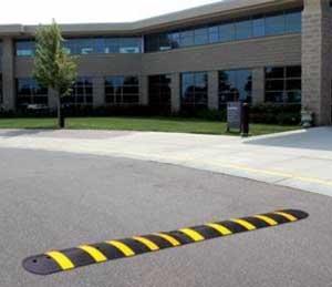 Channeled bottom speed bump allows for cabling or piping.  Portable, temporary and removable.